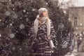 Snowing young woman outdoors winter