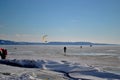 Snowkiter on the frozen Volga River against the backdrop of the blue sky.