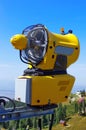 Snowmaking on blue background, in the summer. Yellow Snow cannon in Carpathian Mountains, Romania