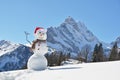 Snowman against Alpine panorama