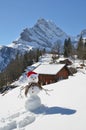 Snowman against Alpine panorama