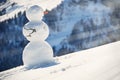 Snowman against Alpine panorama