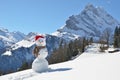 Snowman against Alpine panorama