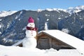 Snowman against Alpine panorama