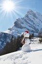 Snowman against Alps