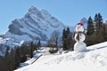 Snowman against Alps