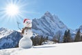 Snowman against Alps
