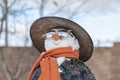 Snowman in Asian clothes, sunglasses and straw hat in the yard