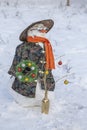Snowman in Asian clothes, sunglasses and straw hat in the yard. Closeup