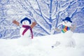 Snowman on a background snow-covered fir branches. Snowman in snow forest. Snowmen. Snowman isolated on snow background Royalty Free Stock Photo