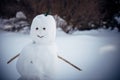 Snowman on a blurry white background, close-up. Winter, New Year, outdoor games. Copy space Royalty Free Stock Photo