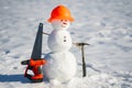 Snowman builder with construction tools. Winter snowman worker. Snow man engineer with hardhat. Funny snowman builder. Snowman Royalty Free Stock Photo