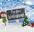 Snowman with chalkboard and message Time for a winterbreak Royalty Free Stock Photo