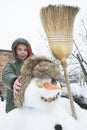 Snowman and child in the yard Royalty Free Stock Photo