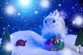 Snowman with Christmas balls on snow over fir-tree, night sky and moon. Shallow depth of field. Christmas background Royalty Free Stock Photo