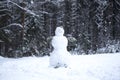 A snowman in a clearing in the forest.Festive Christmas decorations Royalty Free Stock Photo
