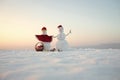 Snowman couple with present box in basket. Royalty Free Stock Photo