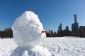Snowman Face on the Sheep Meadow at Central Park in New York City during the Winter with the Midtown Manhattan Skyline in the Back Royalty Free Stock Photo