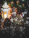 Snowman Family With Glowing Lantern and Christmas Tree