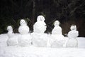 Snowman Family in Pine Tree Forest Scene