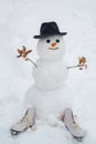 Snowman the friend is standing in winter hat and scarf with red nose. Snowman and snow day. Winter scene with snowman on Royalty Free Stock Photo