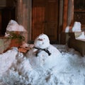 Snowman in front of doorway