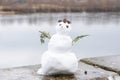 Snowman girl on the background of the river in nature