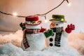 Snowman and light bulb stand among pile of snow at silent night, Merry christmas and Happy new year night. Royalty Free Stock Photo