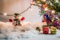 Snowman and light bulb stand among pile of snow at silent night, Merry christmas and Happy new year night. Royalty Free Stock Photo