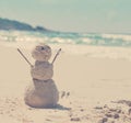 Snowman made of sand on a background of the tropical warm sea Royalty Free Stock Photo