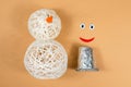 Snowman made of threads. A set of items for making a handmade snowman. Threads, inflated balls, glue. Step 5.
