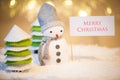 Snowman with Merry Christmas sign Royalty Free Stock Photo
