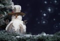 Snowman next to Christmas tree