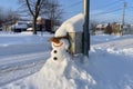 snowman next to a snow-covered mailbox