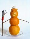 Snowman from oranges with broom and cream Royalty Free Stock Photo