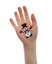 Snowman painted on child hand.