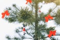 Snowman and red bows are hanging on Christmas pine tree. Natural photo in frozen forest. Happy holidays postcard. New year`s Royalty Free Stock Photo