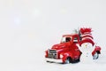 Snowman in a red hat near red christmas truck pickup, on a white background. christmas pickup. Merry christmas and happy new year Royalty Free Stock Photo