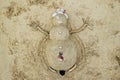 A snowman from sand and seashells on a beach. Royalty Free Stock Photo