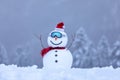 Snowman in santa hat and red tinsel in ski goggles on snowy field. Beautiful winter background. Merry christmas and happy new year Royalty Free Stock Photo