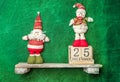 snowman and santa toys on a shelf, wooden calendar with 25 december date, christmas banner, copy space for promo or ad