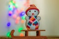 Snowman sitting on a sled Royalty Free Stock Photo