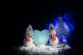 Snowman and Snow Woman with Heart on snow in dark background. New Year and Christmas conceptual image with fir tree. Sweet Snowman Royalty Free Stock Photo