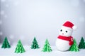 Snowman in snowy winter background with paper cut christmas tree Royalty Free Stock Photo