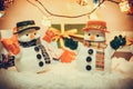 Snowman stand among pile of snow at silent night with a light bulb, Merry christmas and new year night. Royalty Free Stock Photo