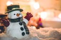 Snowman stand among pile of snow at silent night with a light bulb,Merry christmas and new year night. Royalty Free Stock Photo