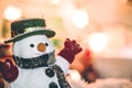 Snowman stand among pile of snow at silent night, light up the hopefulness and happiness in Merry christmas and Royalty Free Stock Photo