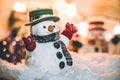 Snowman stand among pile of snow at silent night, light up the hopefulness and happiness in Merry christmas and Royalty Free Stock Photo