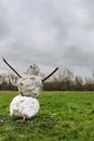 Snowman standing on a green grass in a park Royalty Free Stock Photo
