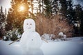 Snowman in sunny winter forest against the trees and white snow. New Year, active games outdoor Royalty Free Stock Photo